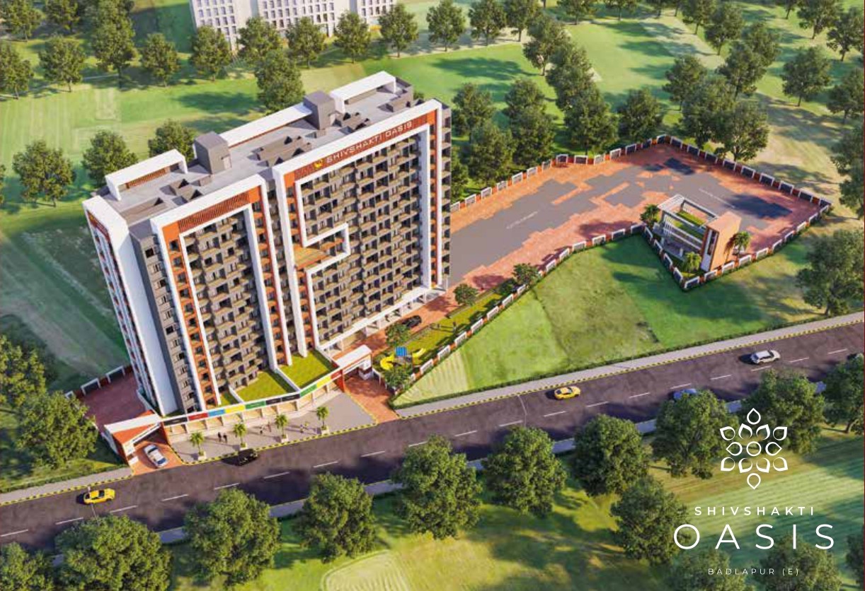 Aerial image of Shivshakti Oasis residential tower in Badlapur East surrounded by greenery, showcasing building layout and open space.