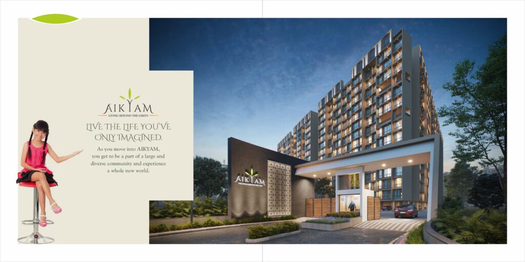 Illuminated entrance of Aikyam residential complex in Upper Kharghar with modern architecture, security gate, and evening lighting.